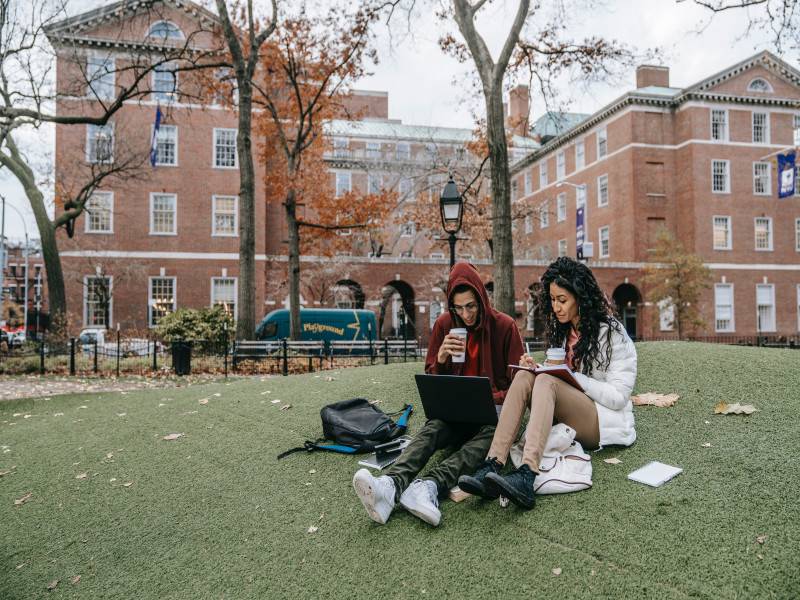 University Students sitting on ground.