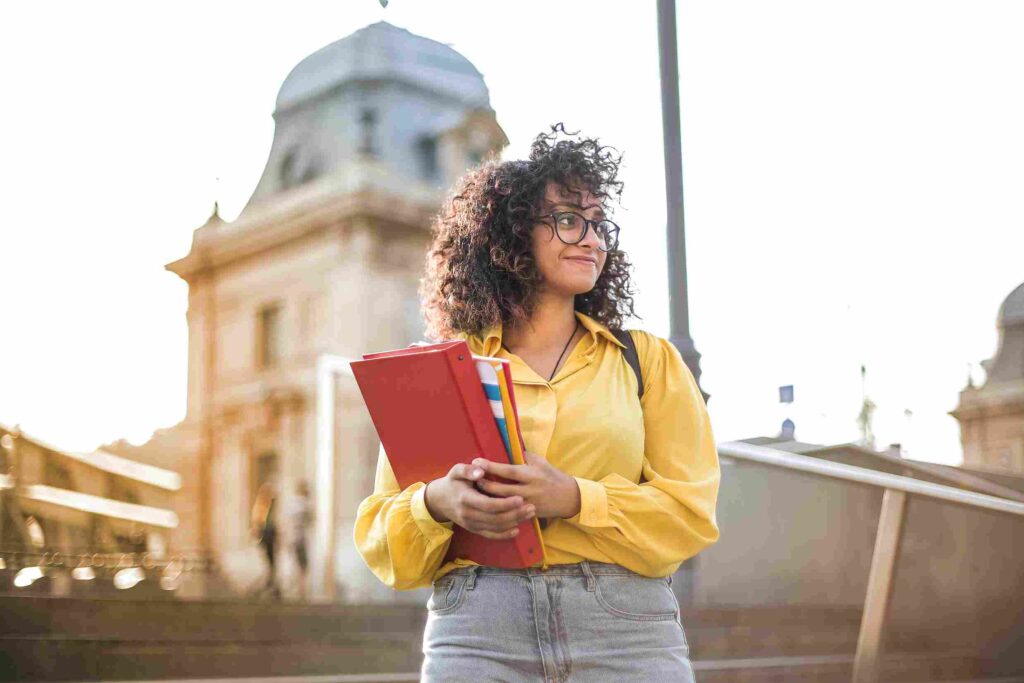 university student holding her books.